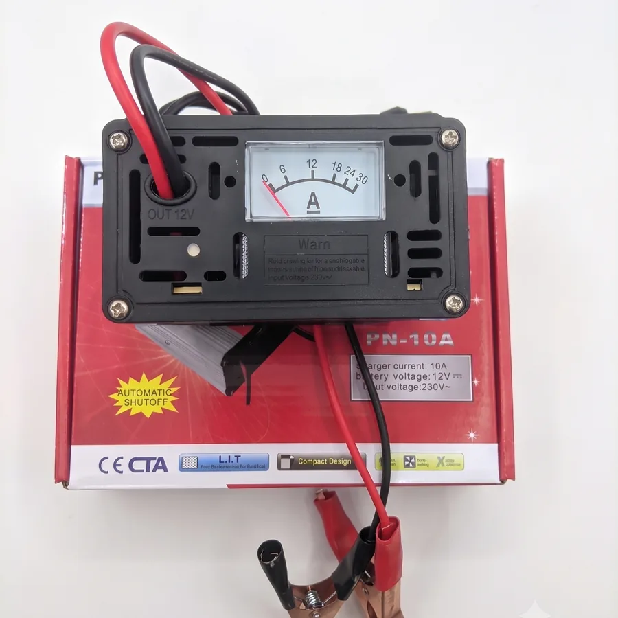 The top of the charger has an analog ammeter reading 0 to 30A and a marked OUT 12V terminal.
