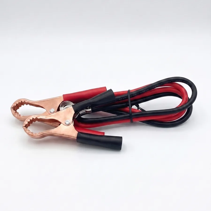 The copper battery clamps and red and black cables that connect the inverter to a 12V battery.