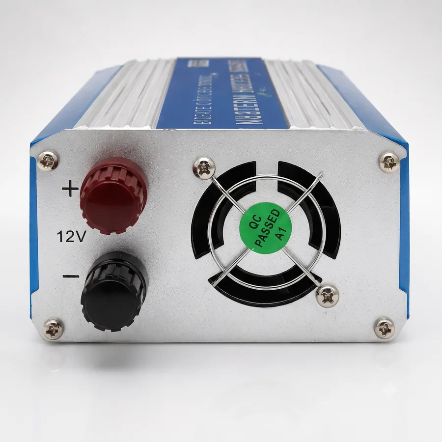 The 12V input terminals, red for plus and black for minus, sitting next to the cooling fan.