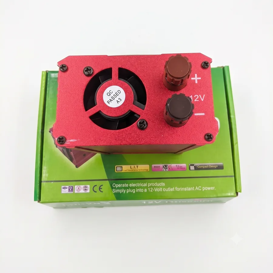 The cooling fan and the + and - 12V screw terminals where the battery leads connect.