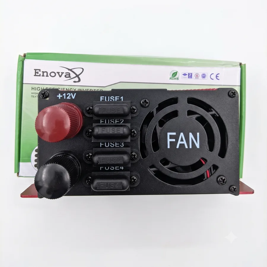 The input side with the +12V and negative battery posts, the four fuses and the cooling fan.